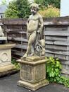 Large garden statue of putti on pedestal