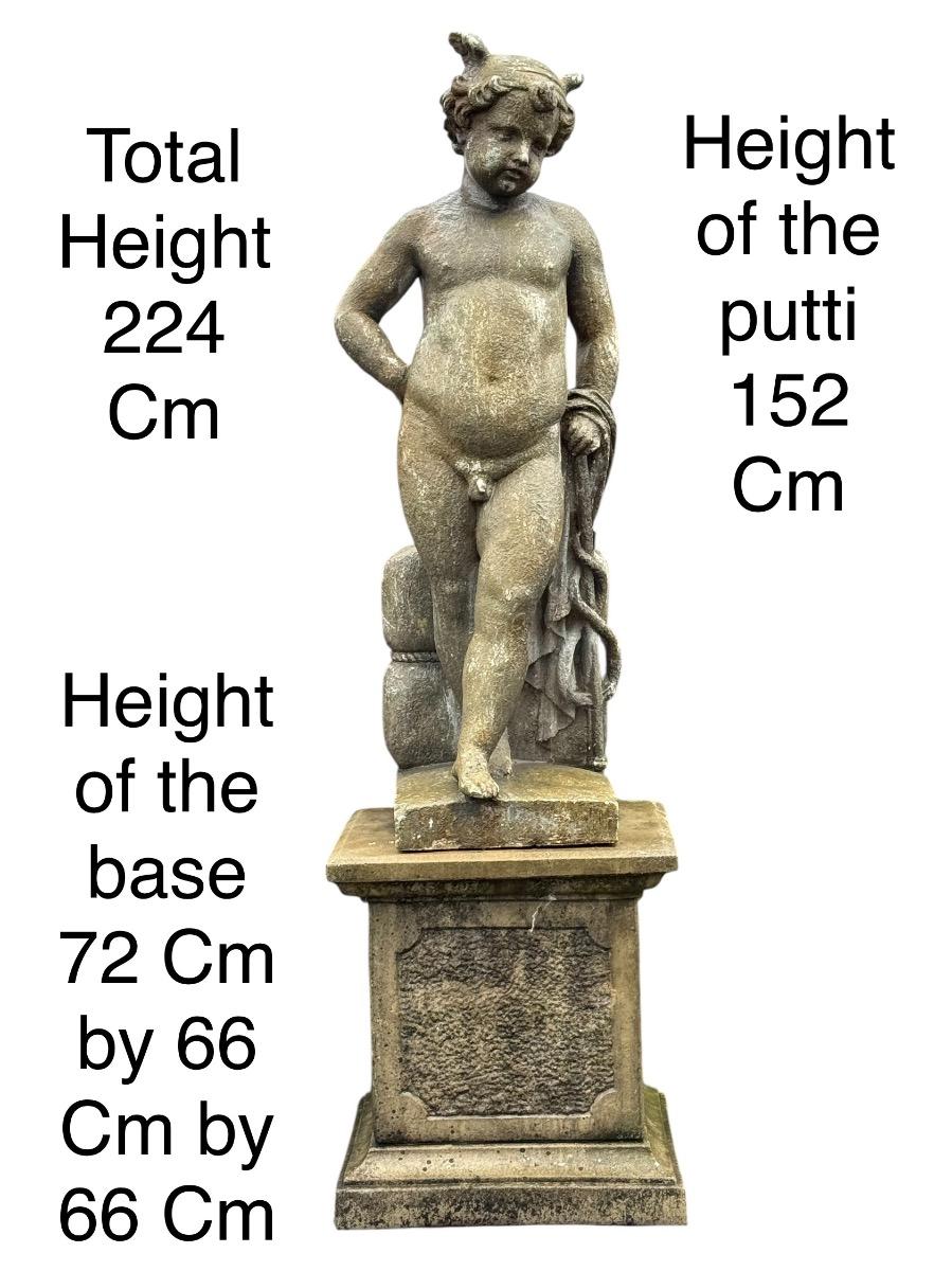 Large garden statue of putti on pedestal