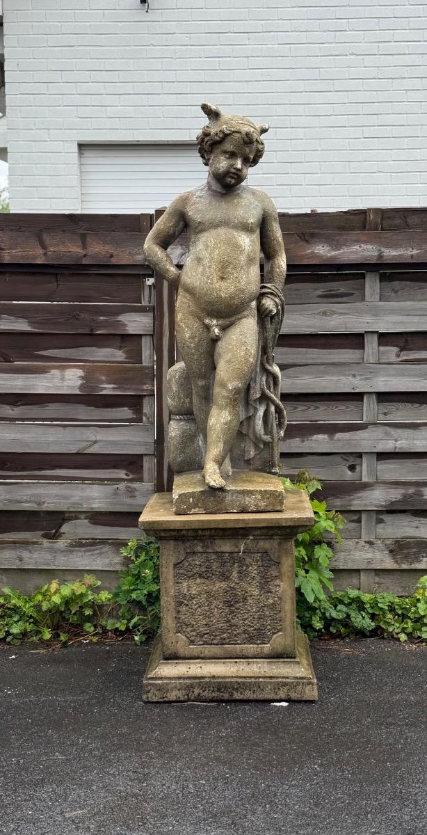Large garden statue of putti on pedestal