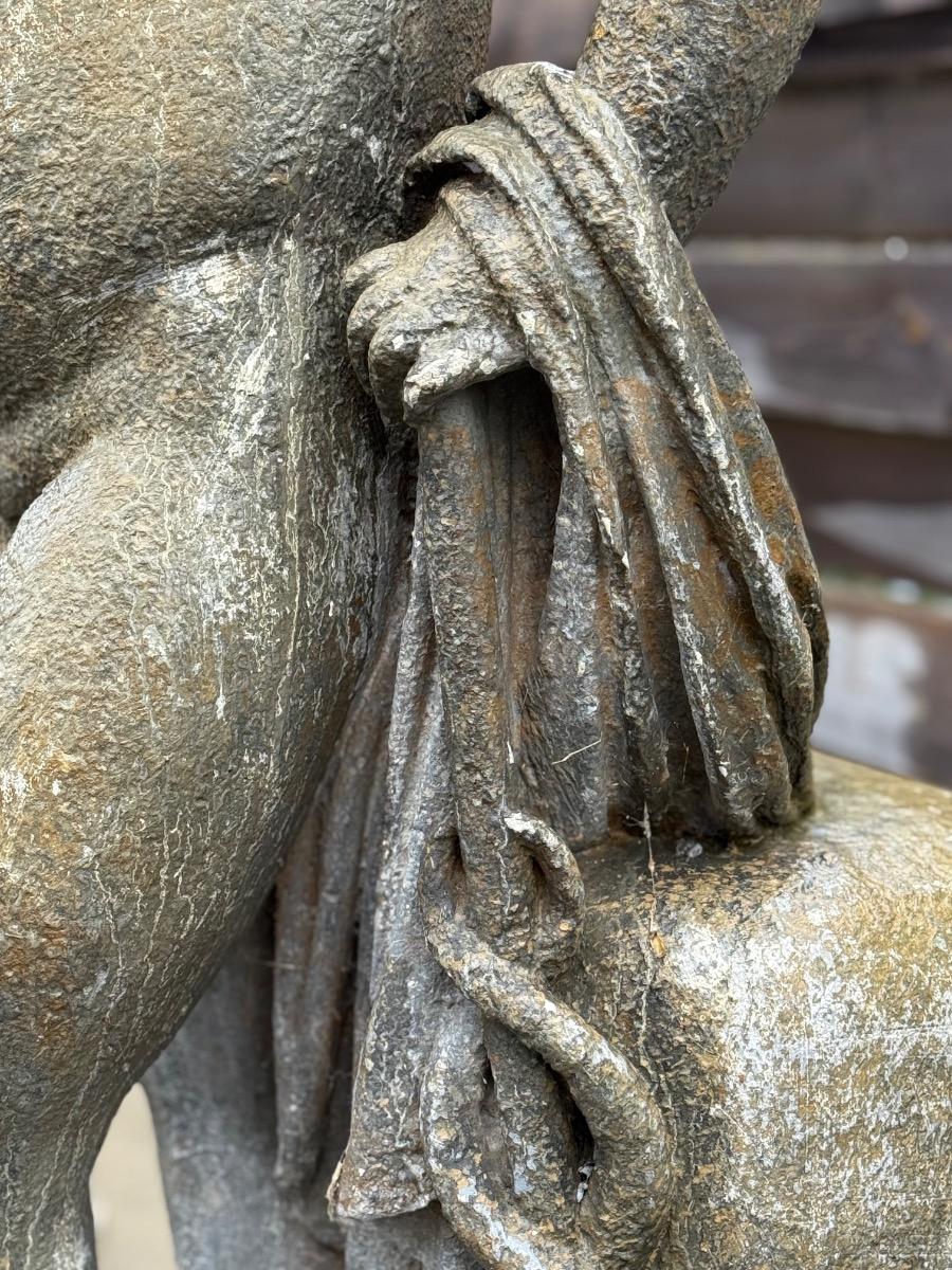 Large garden statue of putti on pedestal