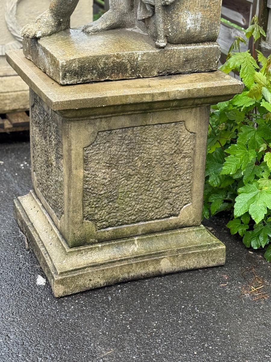 Large garden statue of putti on pedestal