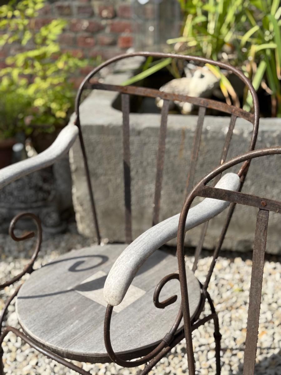 Wrought iron and teak garden chairs 