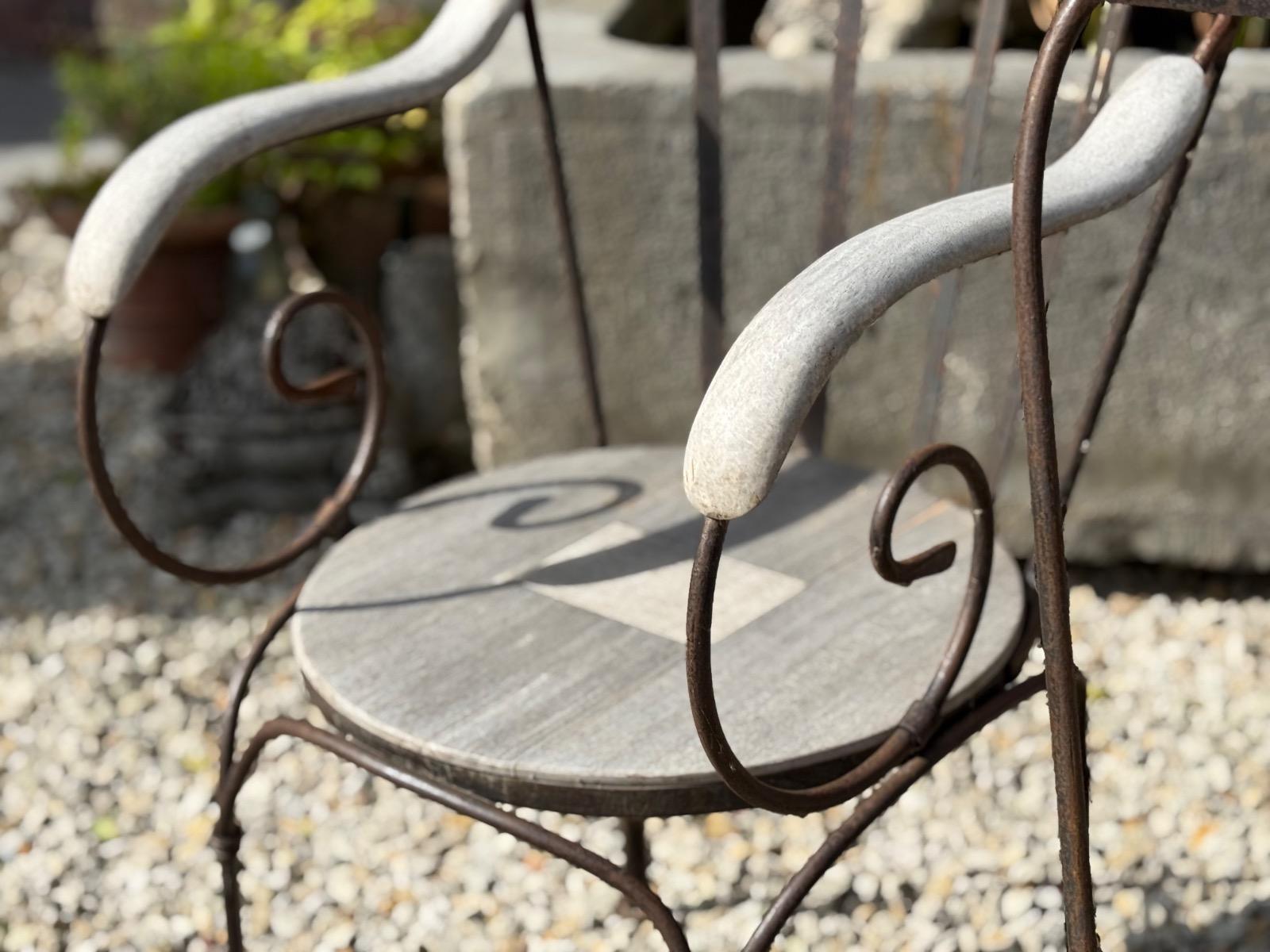 Wrought iron and teak garden chairs 
